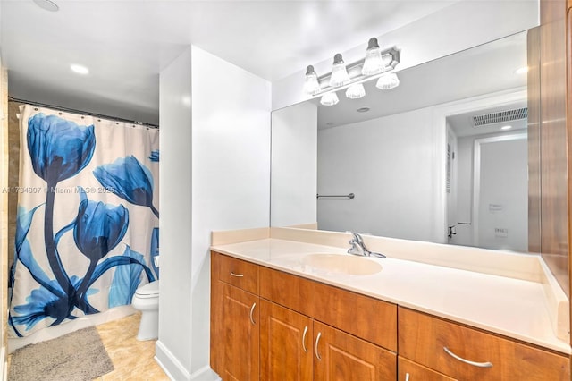 bathroom featuring vanity, tile patterned floors, and toilet