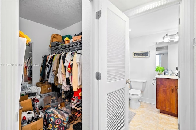 spacious closet with light tile patterned floors