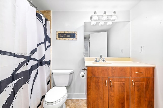 bathroom featuring tile patterned flooring, vanity, and toilet