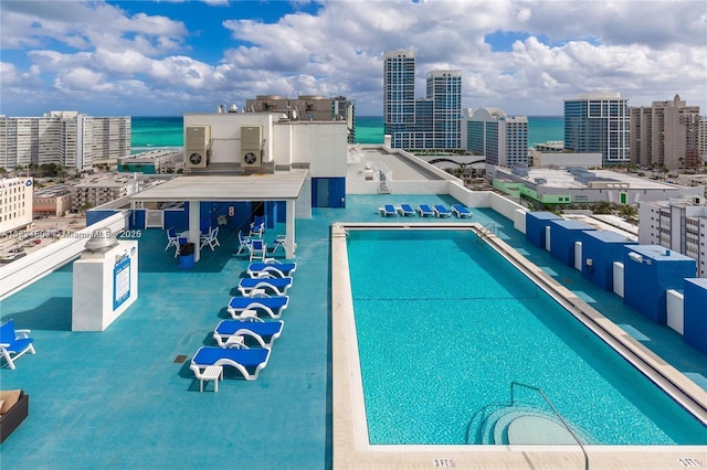 view of swimming pool with a water view