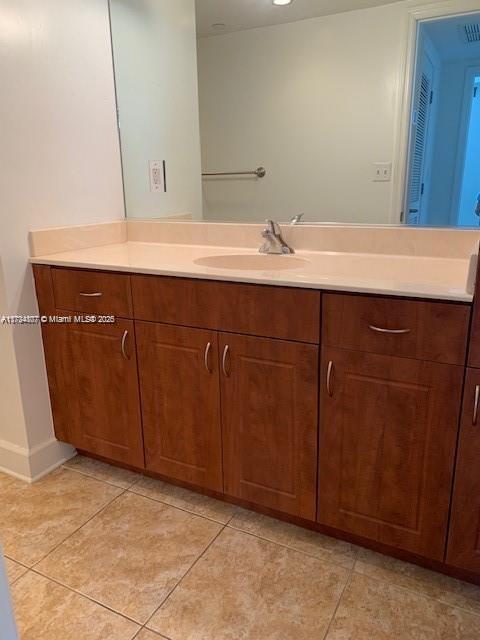 bathroom with tile patterned flooring and vanity