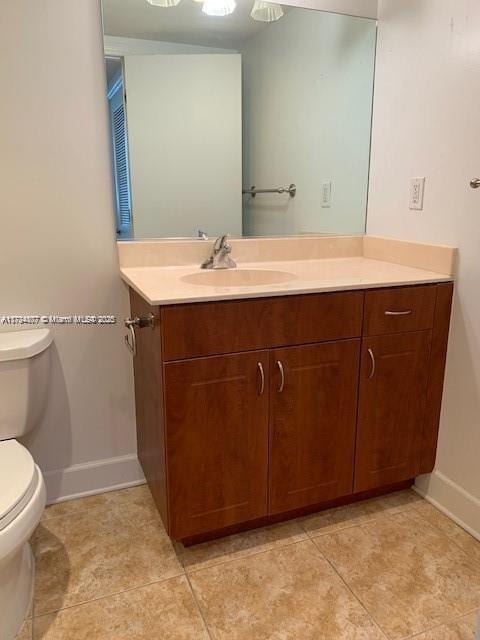 bathroom with vanity, tile patterned floors, and toilet