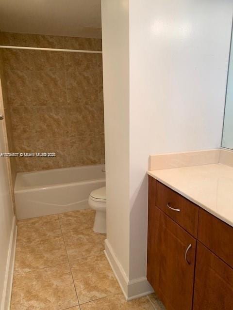 full bathroom with tile patterned flooring, vanity, tiled shower / bath, and toilet