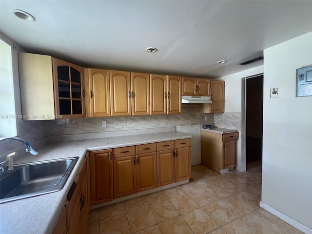 kitchen featuring light tile patterned flooring, sink, and decorative backsplash