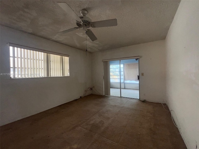 spare room with ceiling fan and a textured ceiling