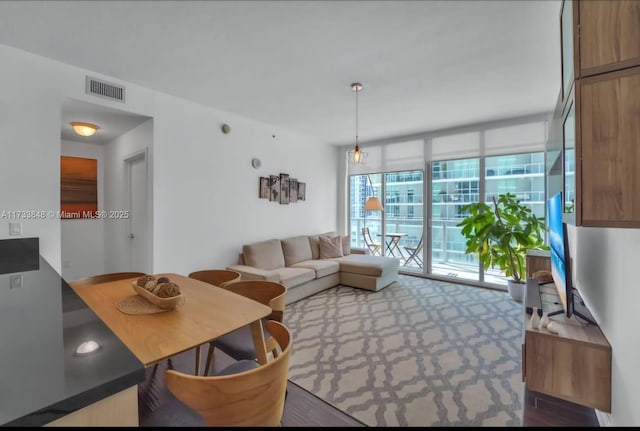 carpeted living room with a wall of windows