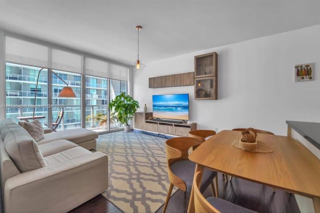 living room with expansive windows and dark colored carpet