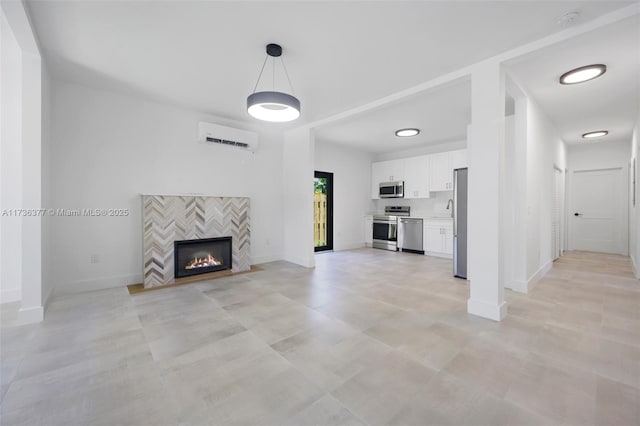 unfurnished living room with a fireplace and an AC wall unit