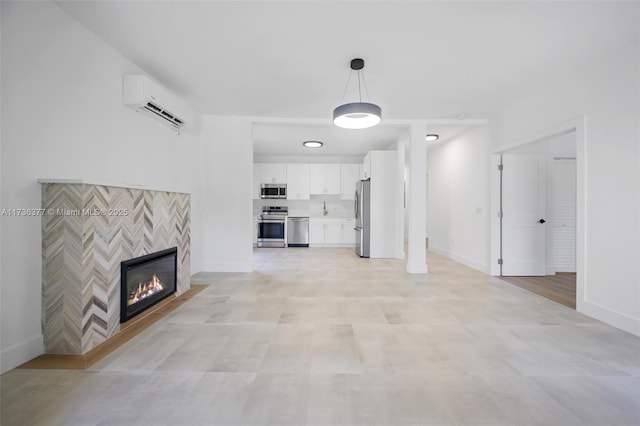 unfurnished living room featuring a fireplace and a wall unit AC