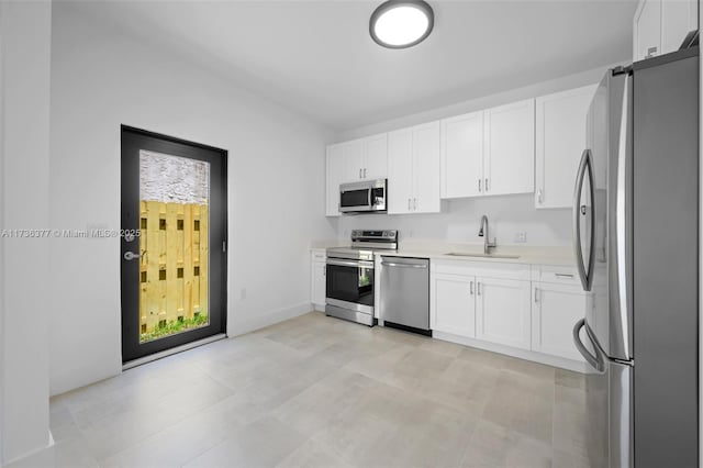 kitchen with white cabinetry, sink, and appliances with stainless steel finishes