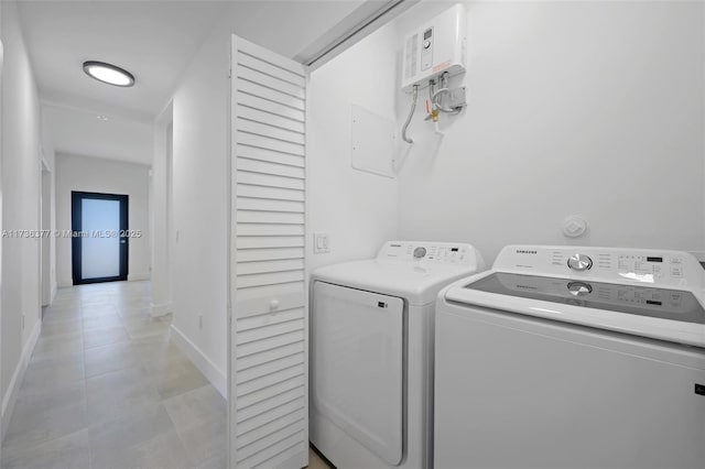 laundry area with light tile patterned floors and washer and clothes dryer