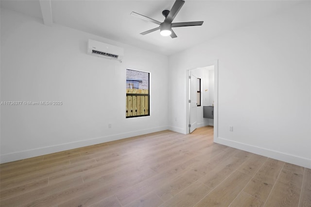 unfurnished room with ceiling fan, a wall mounted AC, and light wood-type flooring