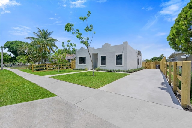 southwest-style home featuring a front lawn