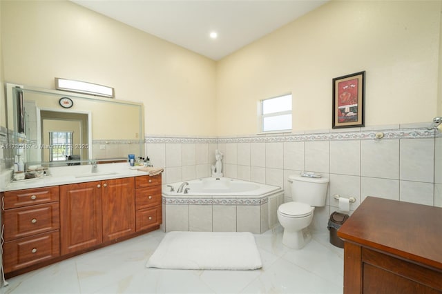 bathroom with toilet, vanity, tiled bath, and plenty of natural light