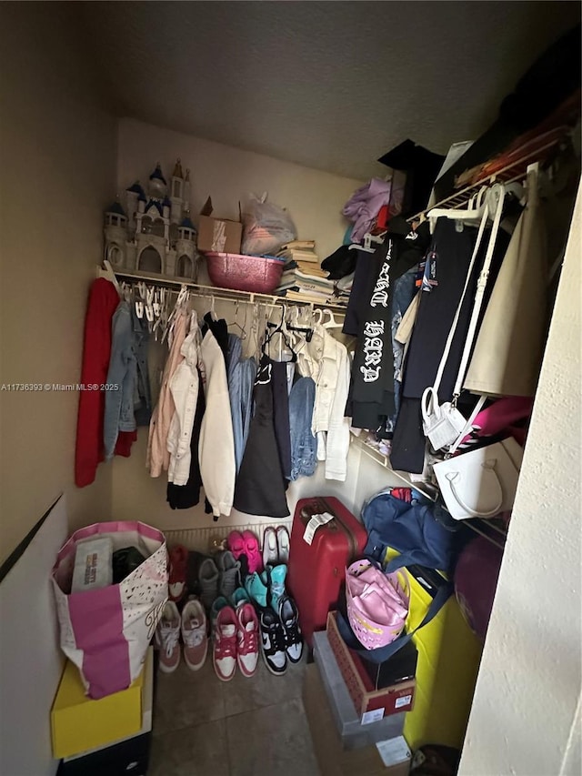 spacious closet featuring tile patterned floors