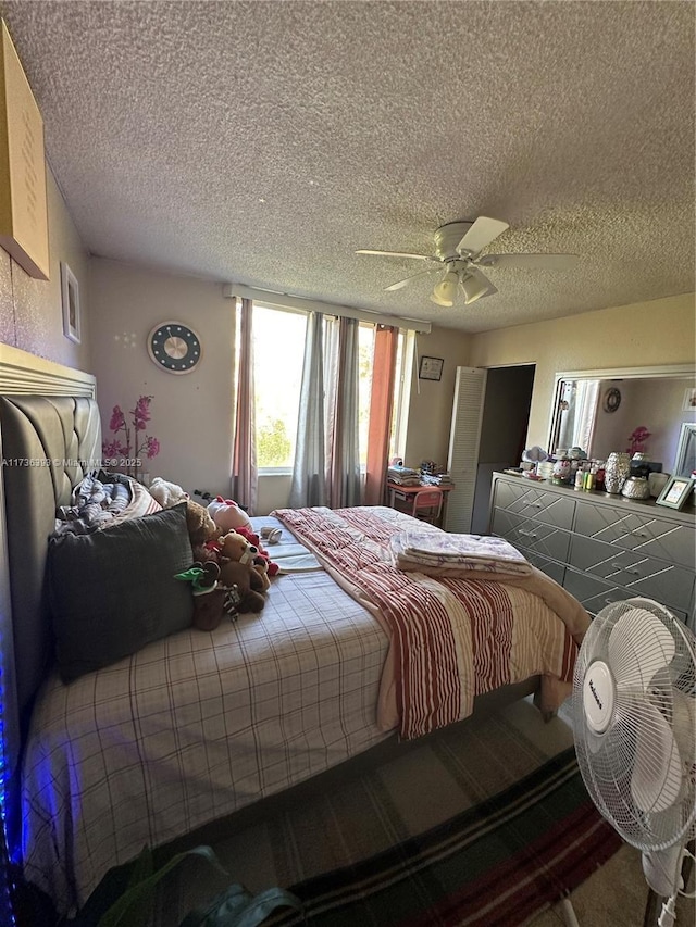 bedroom featuring a textured ceiling and ceiling fan