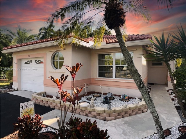 mediterranean / spanish-style home featuring a garage