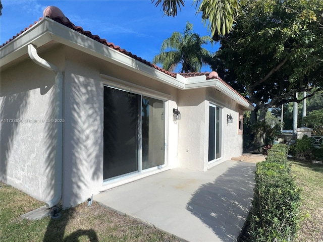 view of property exterior featuring a patio area