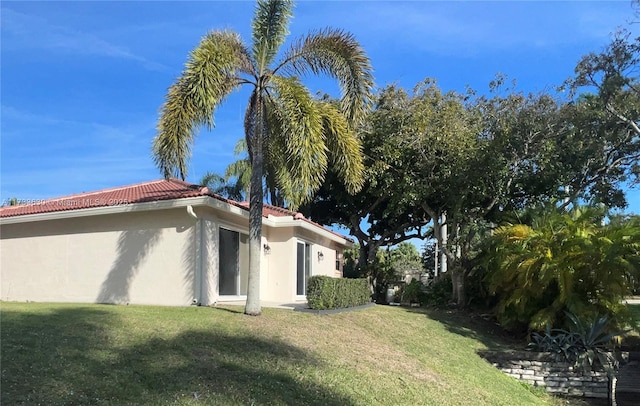 view of side of property with a yard