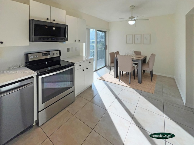 kitchen with stainless steel appliances, light tile patterned floors, white cabinets, and ceiling fan