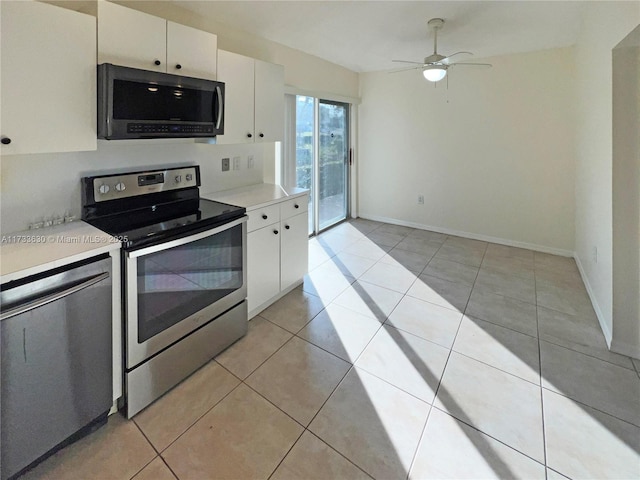 kitchen with ceiling fan, stainless steel appliances, light tile patterned floors, and white cabinets