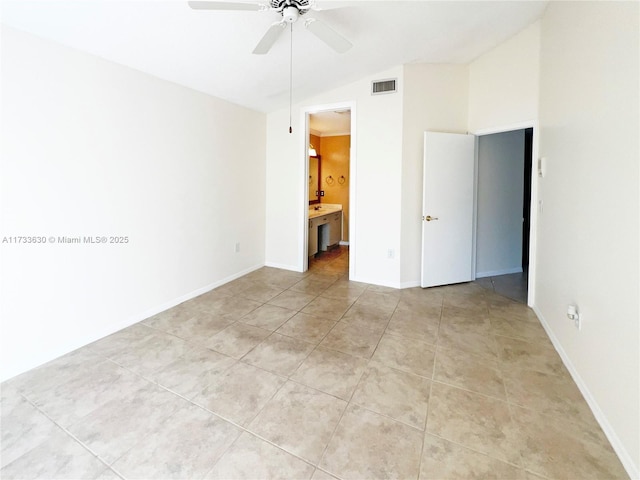 tiled empty room featuring ceiling fan and vaulted ceiling