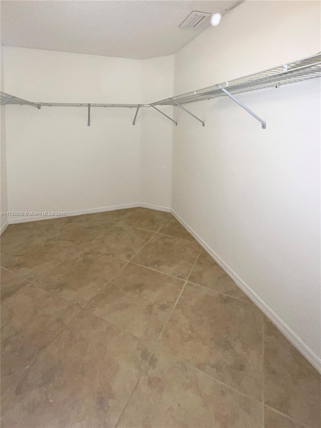 spacious closet featuring tile patterned floors