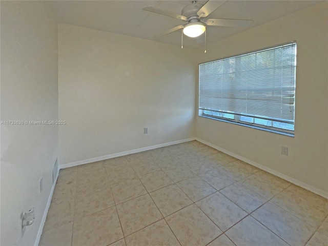 empty room featuring light tile patterned floors and ceiling fan