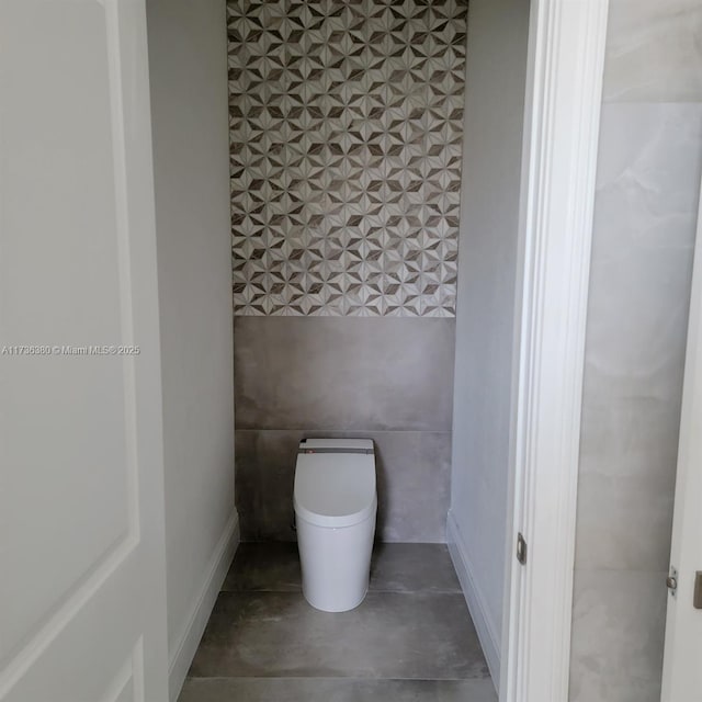 bathroom featuring toilet and concrete floors