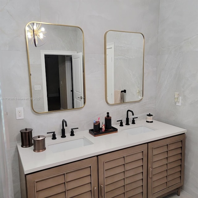 bathroom with vanity and tile walls