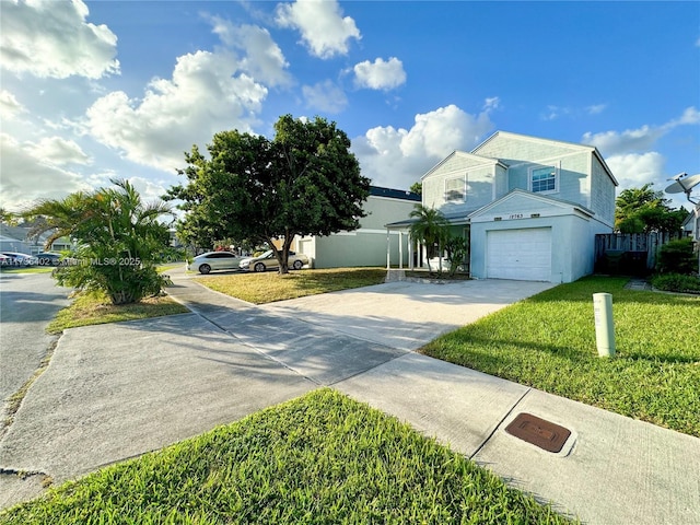 view of front of home with a garage and a front lawn