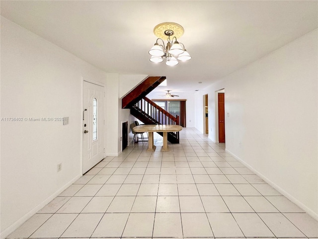 foyer entrance featuring light tile patterned floors and a notable chandelier