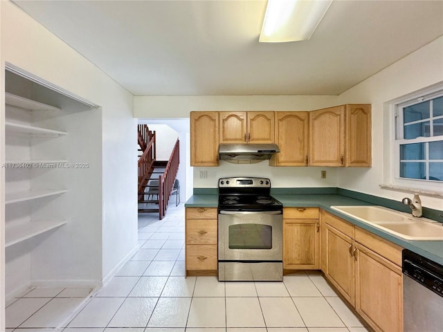 kitchen with stainless steel appliances, sink, light tile patterned floors, and light brown cabinetry