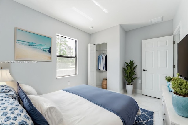 bedroom with a spacious closet and a closet