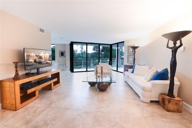 living room featuring floor to ceiling windows