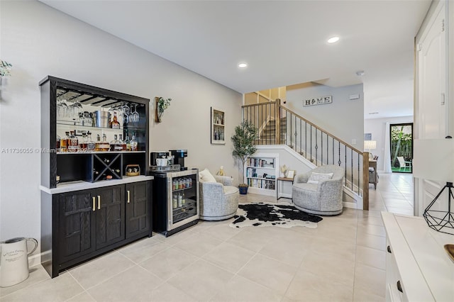 bar with light tile patterned flooring, beverage cooler, and white cabinets