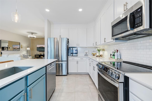 kitchen with hanging light fixtures, white cabinetry, appliances with stainless steel finishes, and blue cabinetry