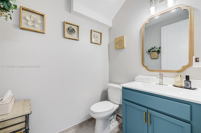 bathroom featuring vanity, tile patterned floors, and toilet