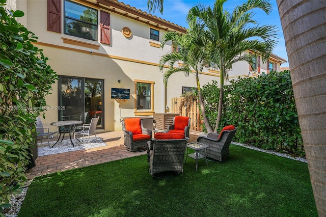 rear view of property featuring a patio area and a lawn