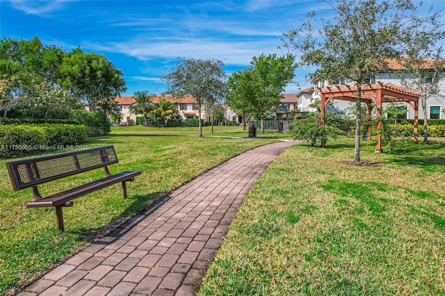 view of home's community featuring a yard and a pergola