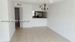 interior space with a notable chandelier and light tile patterned floors