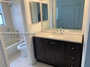 full bathroom with bathtub / shower combination, tile patterned floors, toilet, and vanity