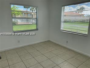 spare room featuring a healthy amount of sunlight and light tile patterned floors