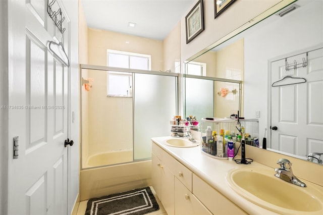 bathroom featuring vanity and shower / bath combination with glass door