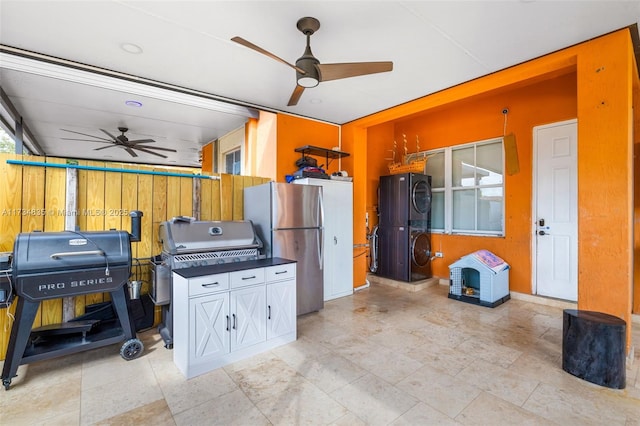 interior space with ceiling fan and stainless steel refrigerator