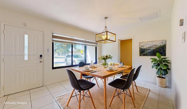 tiled dining room with an inviting chandelier