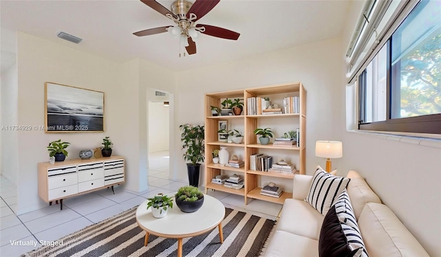 living room with light tile patterned floors and ceiling fan