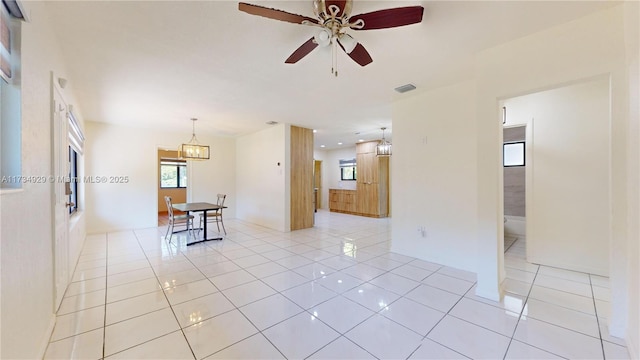 tiled empty room with ceiling fan