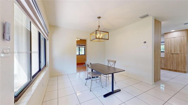 dining room featuring light tile patterned floors and a chandelier