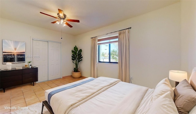 bedroom featuring tile patterned flooring, ceiling fan, and a closet